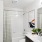 bathroom with bathtub and large mirror